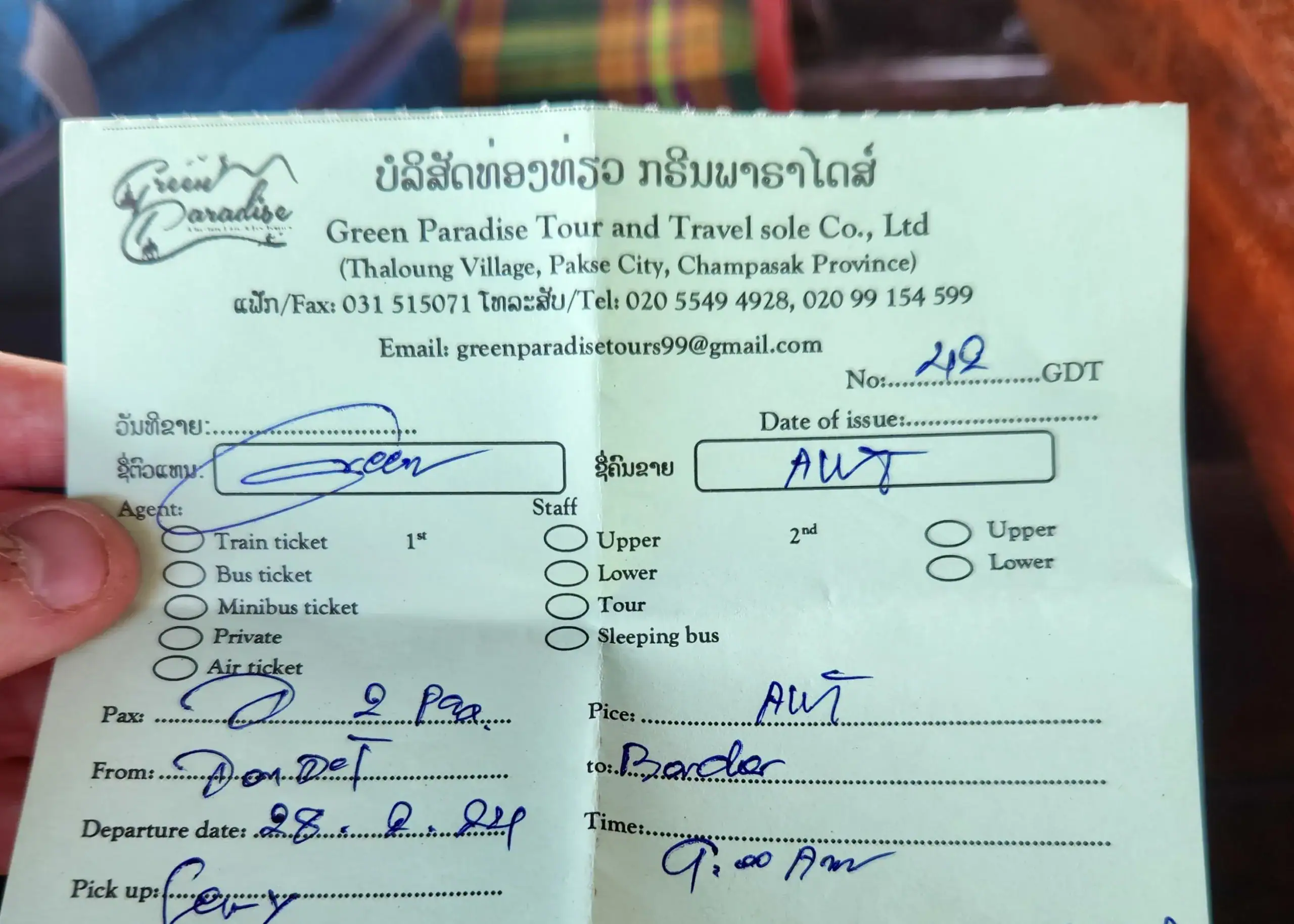 A ticket from Green Paradise Travel showing details of a trip from Don Det in Laos to Siem Reap in Cambodia. It shows the date, the number of people and the pick up time