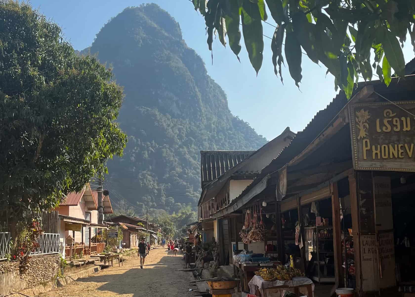 Laos 3 Muang Ngoi village near Nong Khiaw. The picture shows the street with the guesthouses and restaurants with a mountain in thebackground