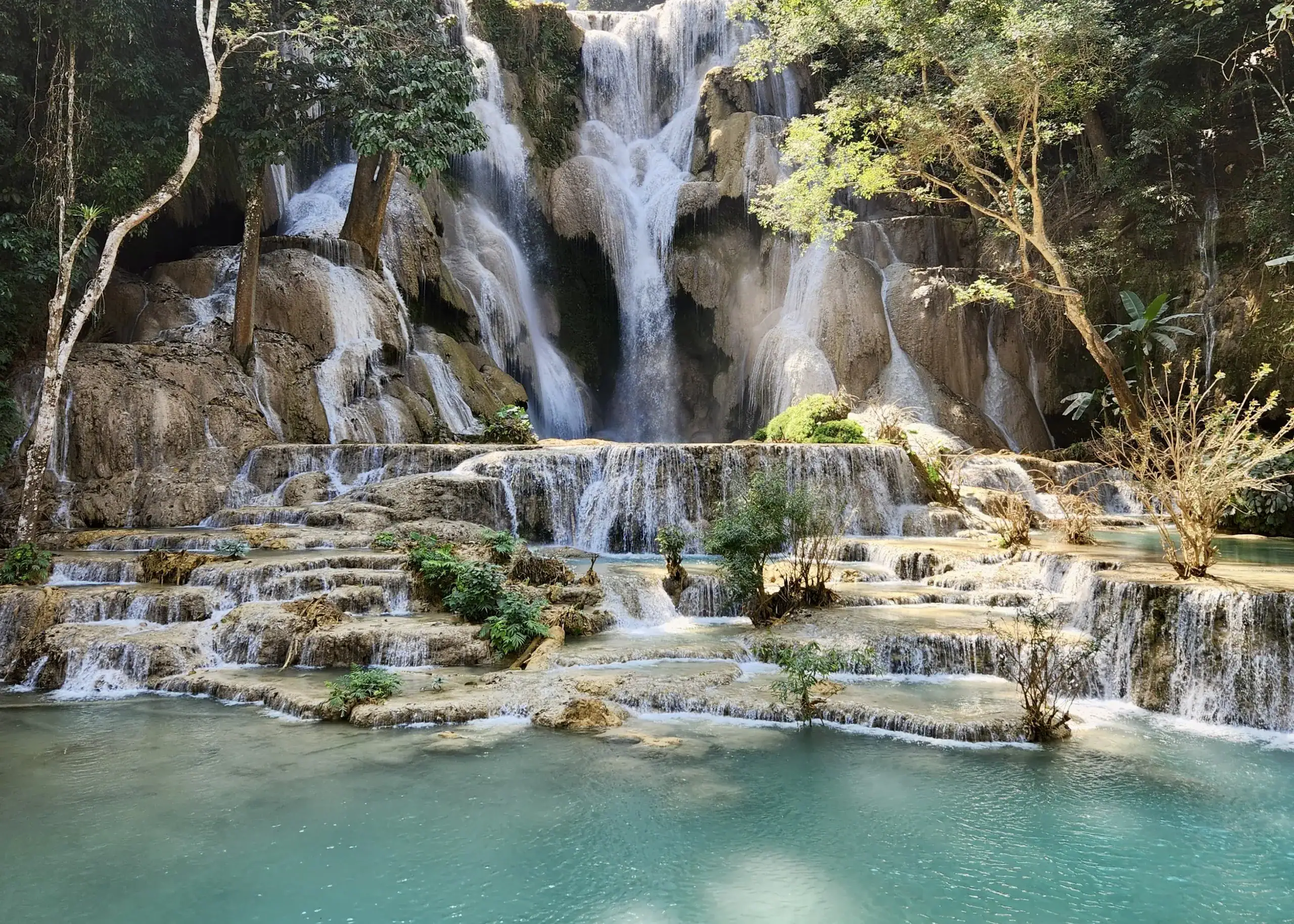 30-Day Laos Itinerary: Unveiling Southeast Asia's Hidden Gem 7 A cascading waterfall in Luang Prabang Laos. Kuang Si Falls sits on limestone rocks creating a yellow colour, and making the water appear a bright blue. A must do when deciding where to go in Laos