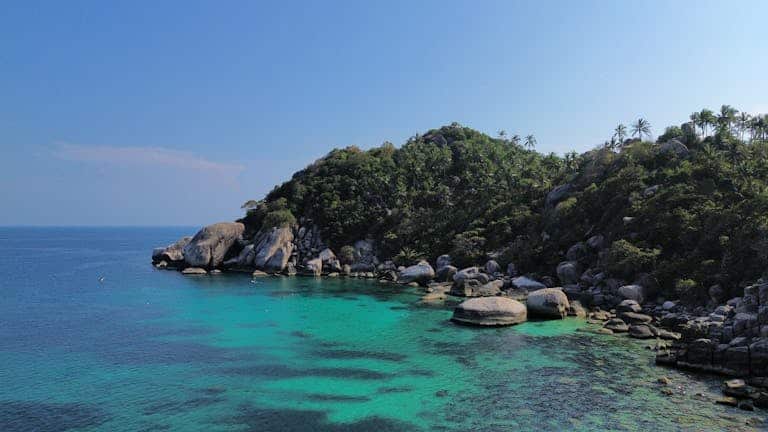 Stunning aerial view of the turquoise waters and lush landscape of Shark Bay, Ko Tao a must-do when choosing where to go in Thailand