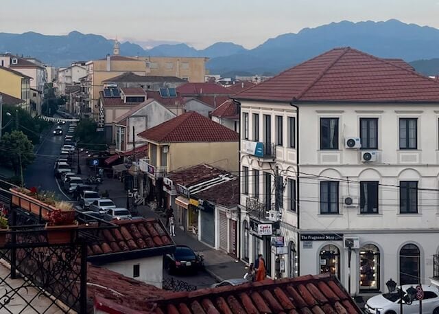 The misty sunset view of the main street in Shkoder from the rooftop of Scodrinon Hostel.