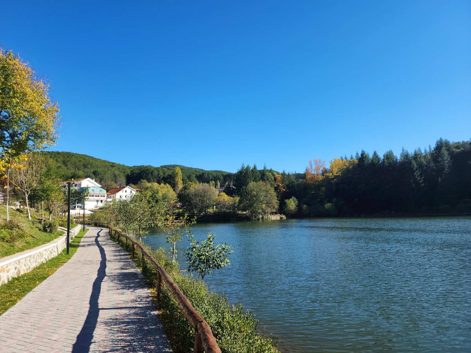 Explore a serene lakeside walkway in Pukë, Shkodër County, Albania's natural beauty.
