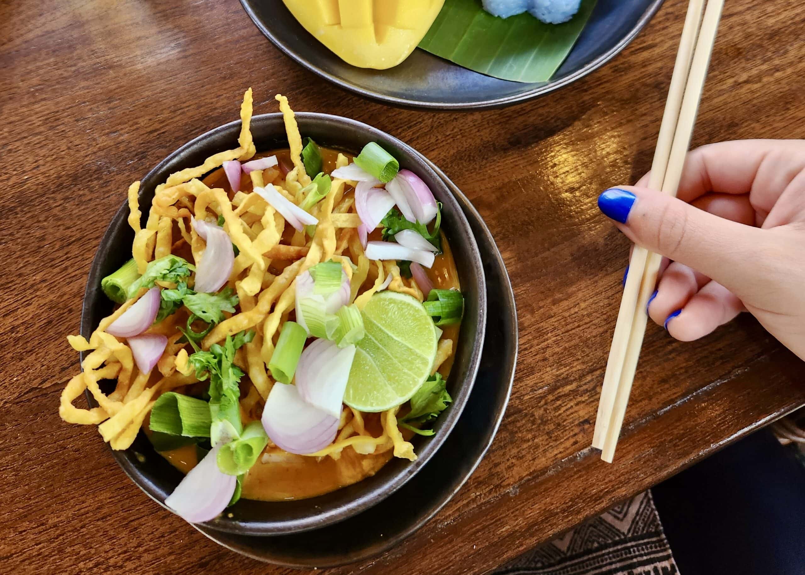 Our Honest Grandma’s Home Cooking School Review 1 A close up of Khao Soi, a classic Northern Thai dish, prepared by a student at Grandma's Home Cooking School.