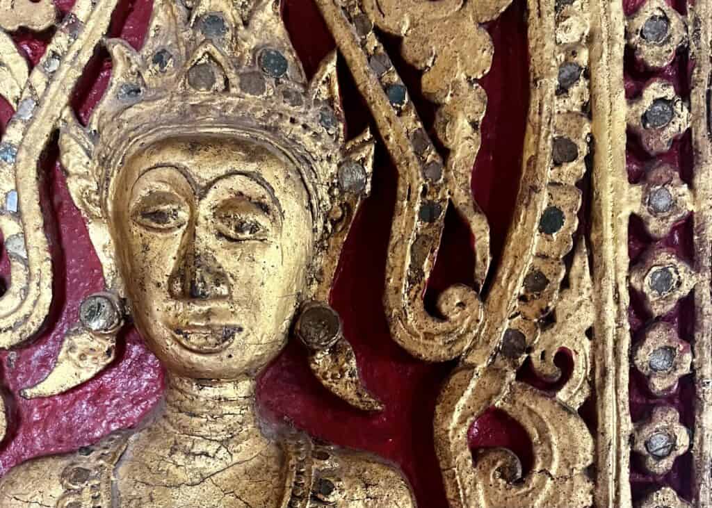 Where to Stay in Luang Prabang: 4 Best Areas for First-Time Visitors 7 An close up of a golden figure at a temple in Luang Prabang Laos.