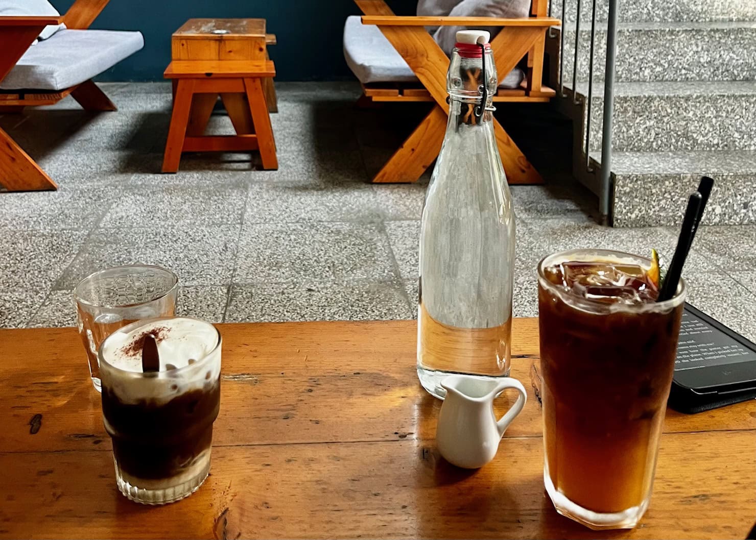Where to Stay in Hoi An (3 Best Areas + Stays We’d Book) 3 A glass of iced coffee, a bottle of water, and a glass of iced tea with lemon.